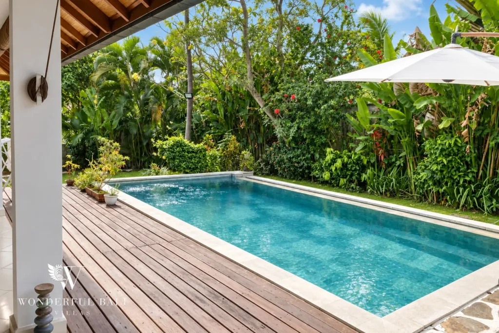 3BR villa for rent in Padonan, Canggu — pool, overflow pool along the timber deck edged with tropical planting