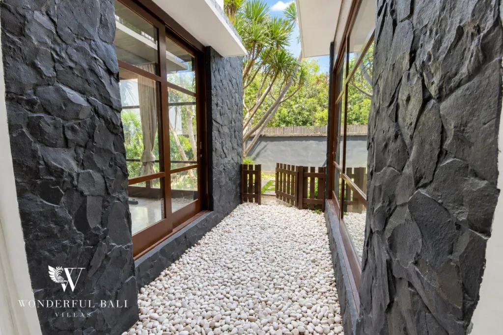 3BR villa for sale in Jimbaran — garden, slate-clad courtyard passage with white pebbles