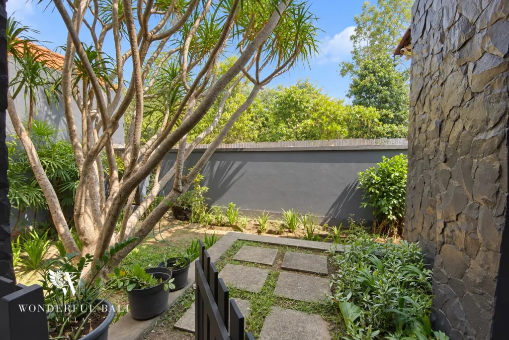 3BR villa for sale in Jimbaran — garden, walled garden with frangipani trees and stepping stones