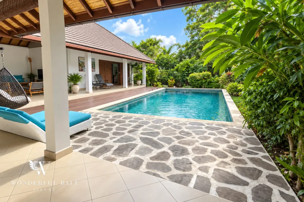 3BR villa for rent in Padonan, Canggu — pool, stone-paved pool terrace with loungers and the villa behind