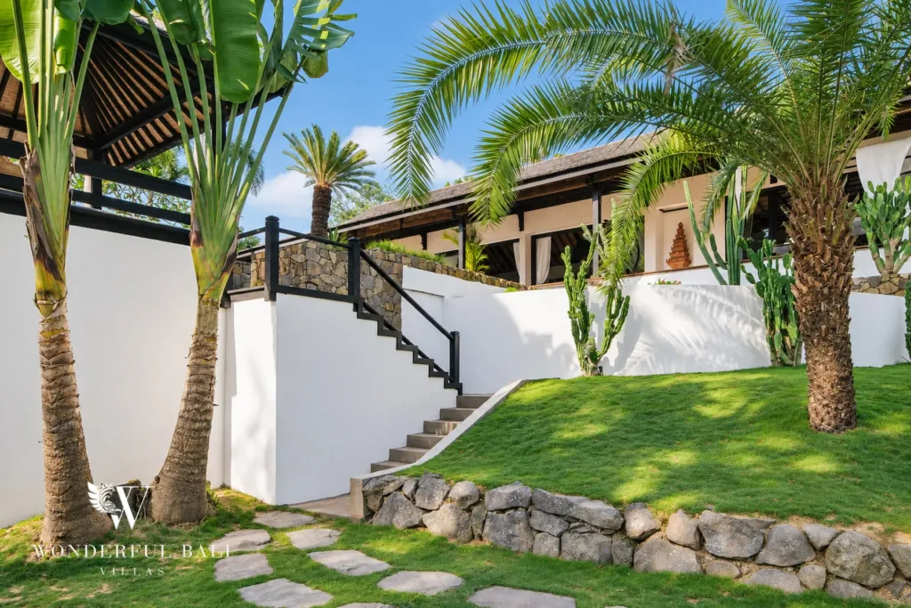 5BR villa for rent in Munggu, Bali — garden, stone steps climbing between planted terraces to the villa