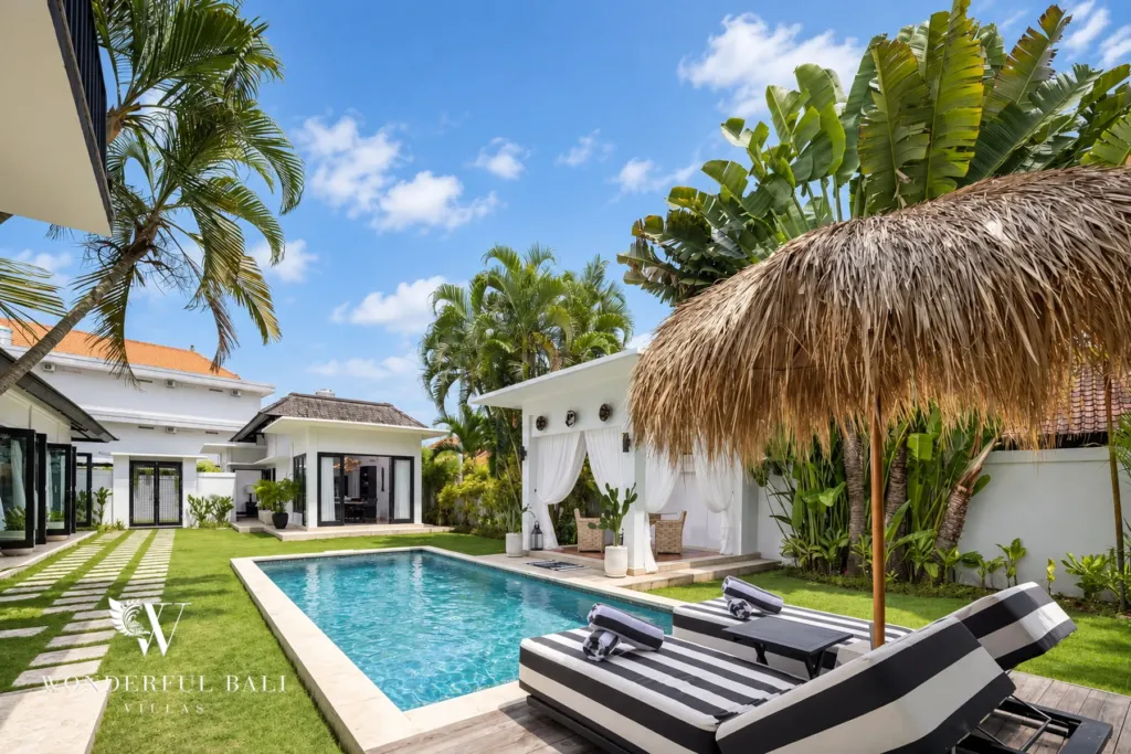 4BR villa for rent in Batu Bolong, Canggu — pool, thatched garden bale with white curtains at the head of the pool