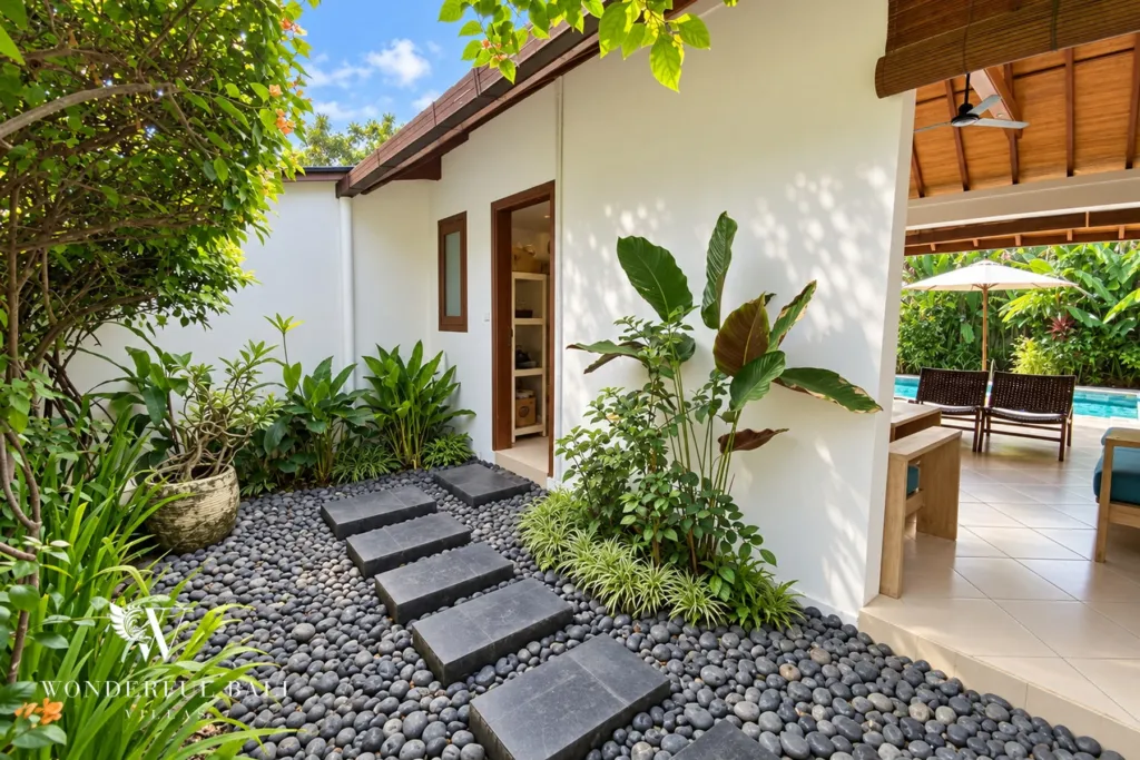 3BR villa for rent in Padonan, Canggu — garden, stepping-stone path between beds of heliconia and palms