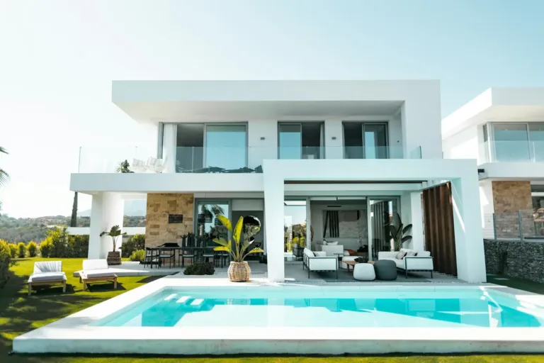 Modern white villa with a swimming pool and garden