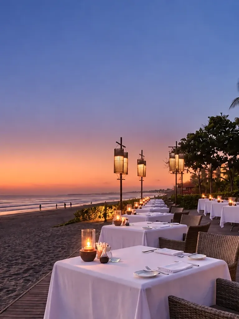 Candlelit tables on the beach in Seminyak, Bali, at sunset