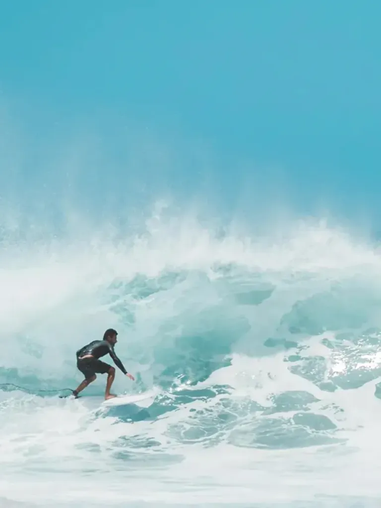 Surfer riding a wave at Uluwatu, Bali