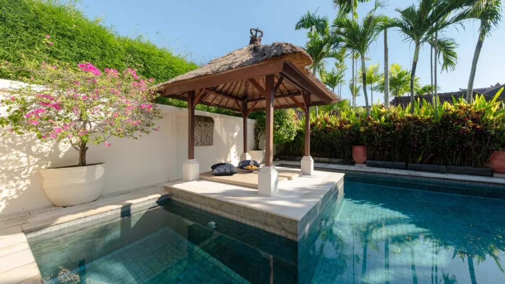 Poolside bale with a cushioned daybed at Villa V Seminyak