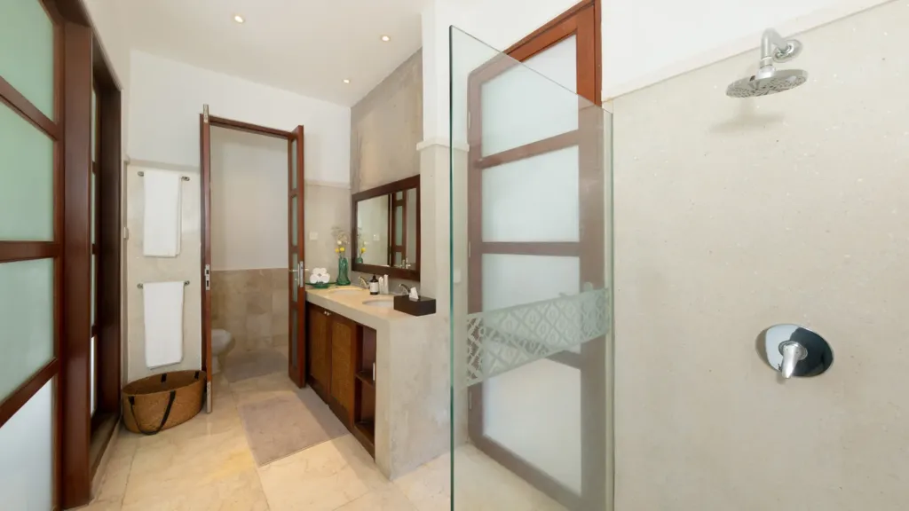 En-suite with a stone vanity and walk-in shower at Villa V Seminyak