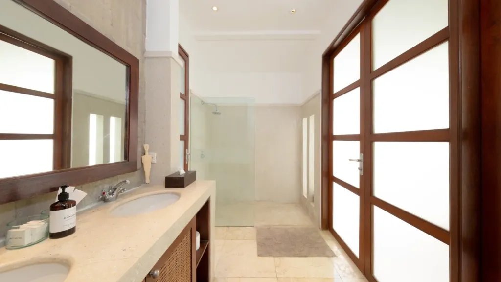 En-suite with a double vanity and glass-screened shower at Villa V Seminyak