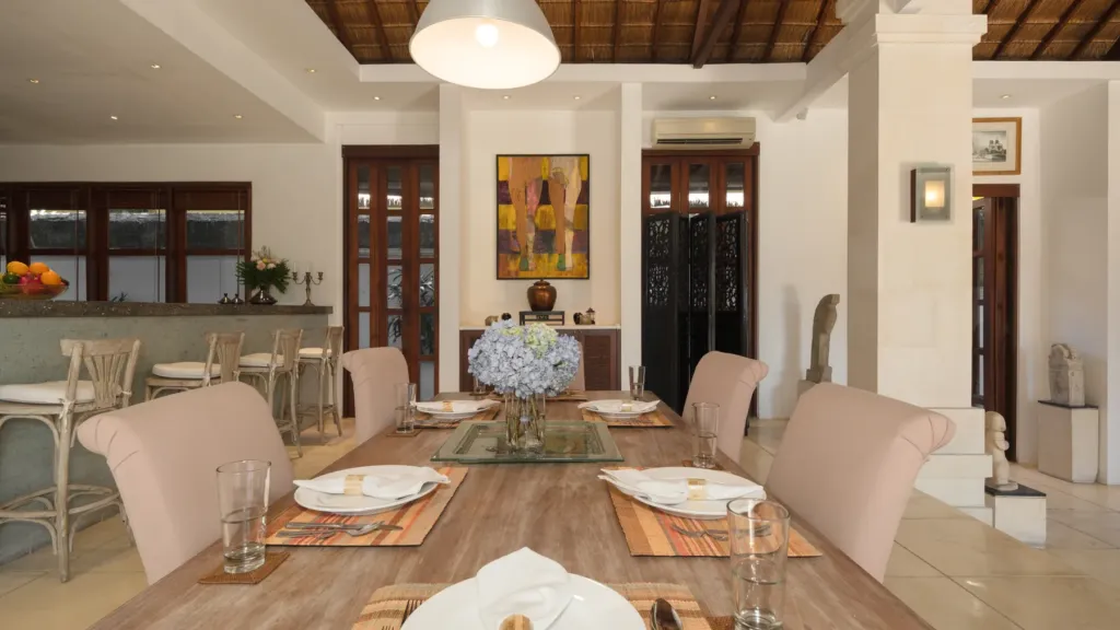 Indoor dining table for six beside the kitchen bar at Villa V Seminyak