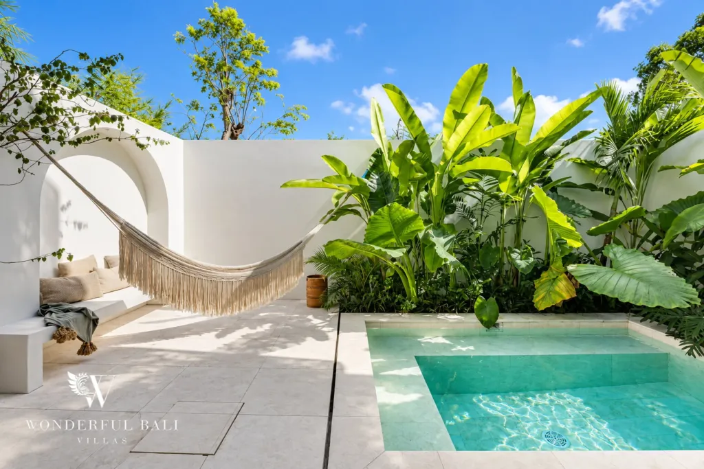 2BR villa for rent in Munggu — private plunge pool in a white courtyard with hammock and tropical garden