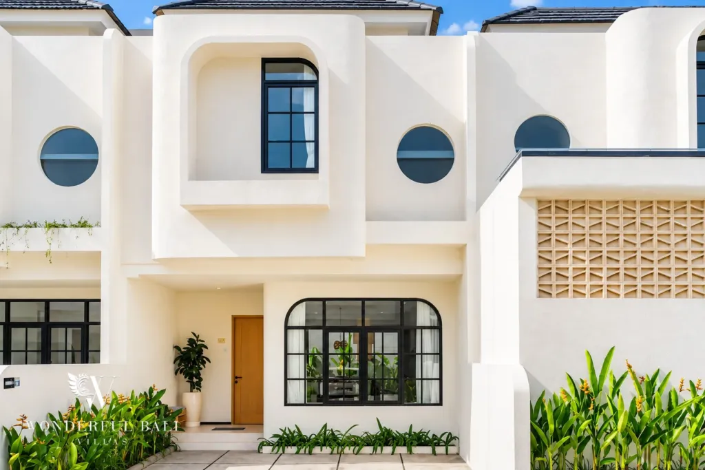 2BR villa for sale in Sanur — Santorini-style white villa with curved walls, porthole windows and a tropical garden