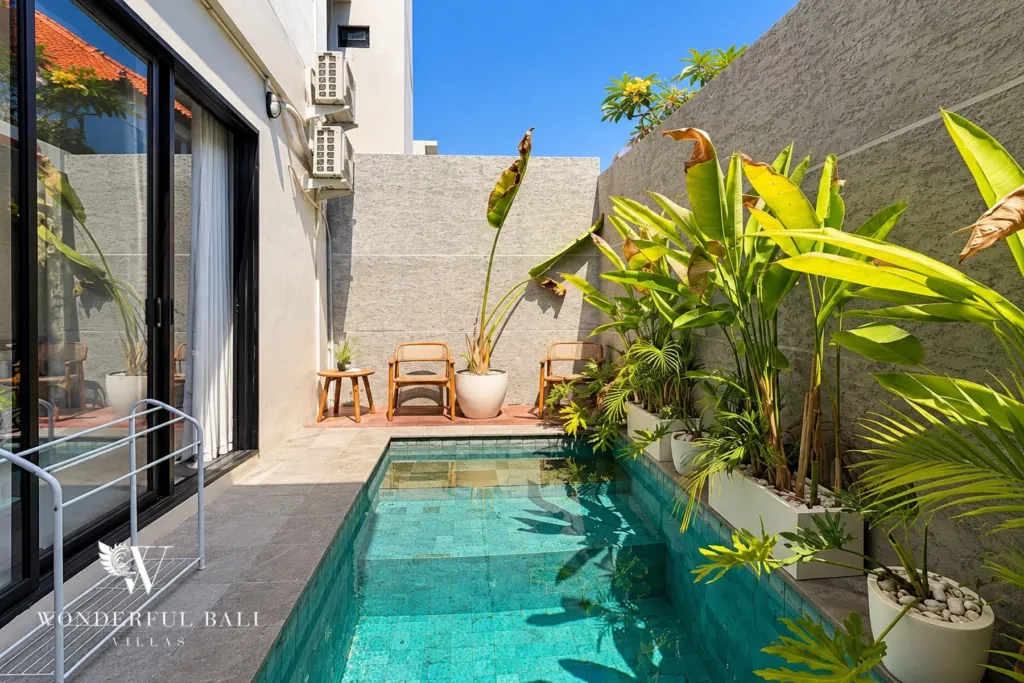 2BR villa for sale in Sanur — private pool with tropical planting and stone wall