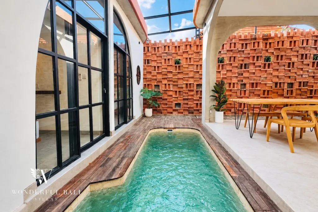 2BR villa for sale in Sanur — private pool with timber deck and terracotta breeze-block wall