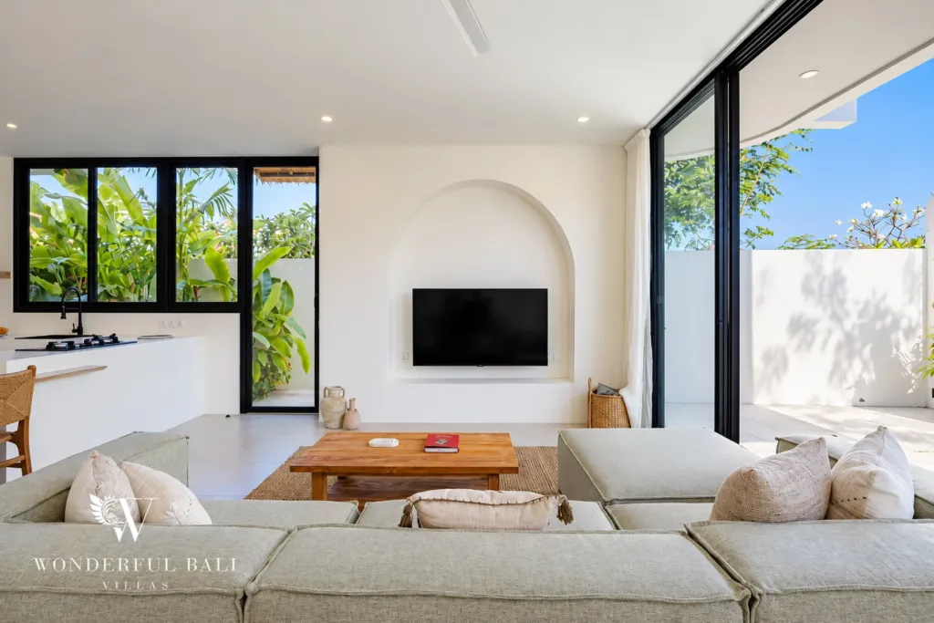 2BR villa for rent in Munggu — living room with sofa and TV in an arched niche