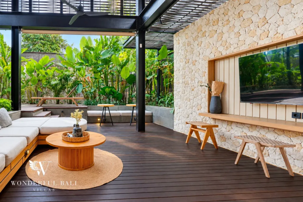 4BR villa for sale in Canggu — living deck with stone media wall and TV