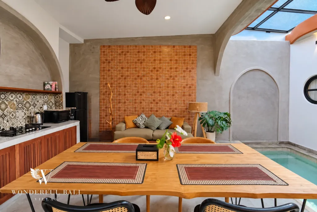 2BR villa for sale in Sanur — timber dining table for six beside the pool
