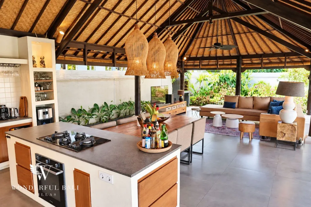 3BR villa for rent in Tabanan — kitchen island with gas hob and oven under an alang-alang roof