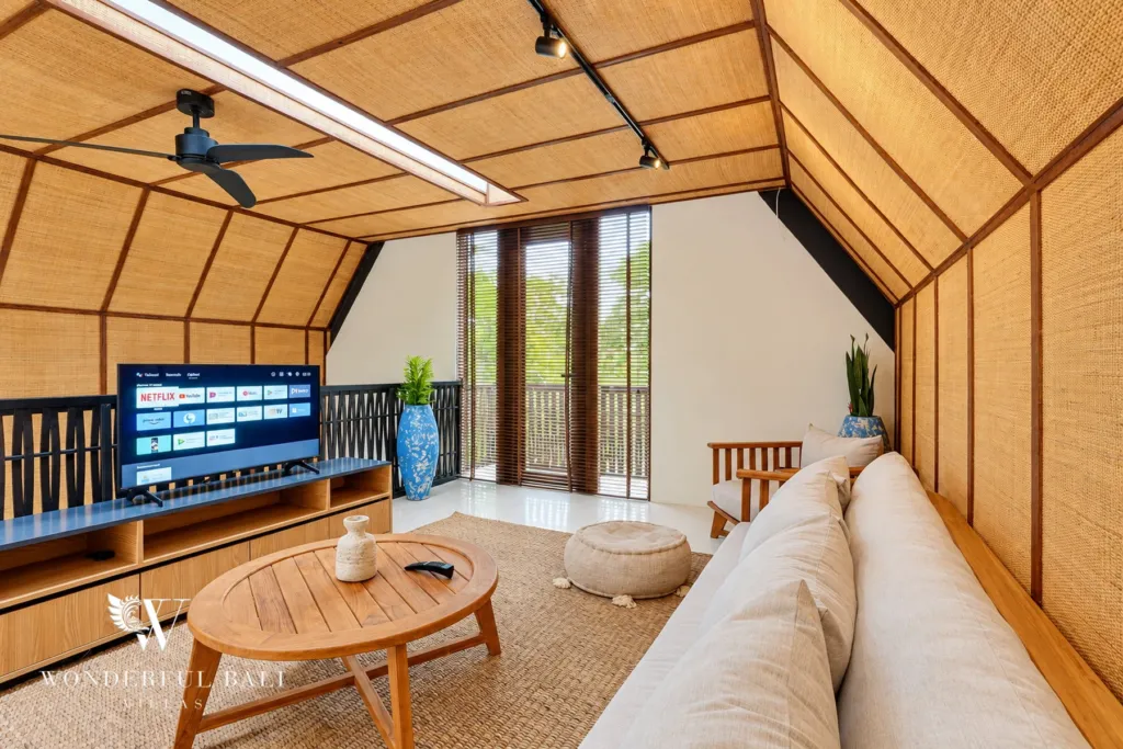 4BR villa for sale in Canggu — upper lounge with sofa, TV and balcony doors
