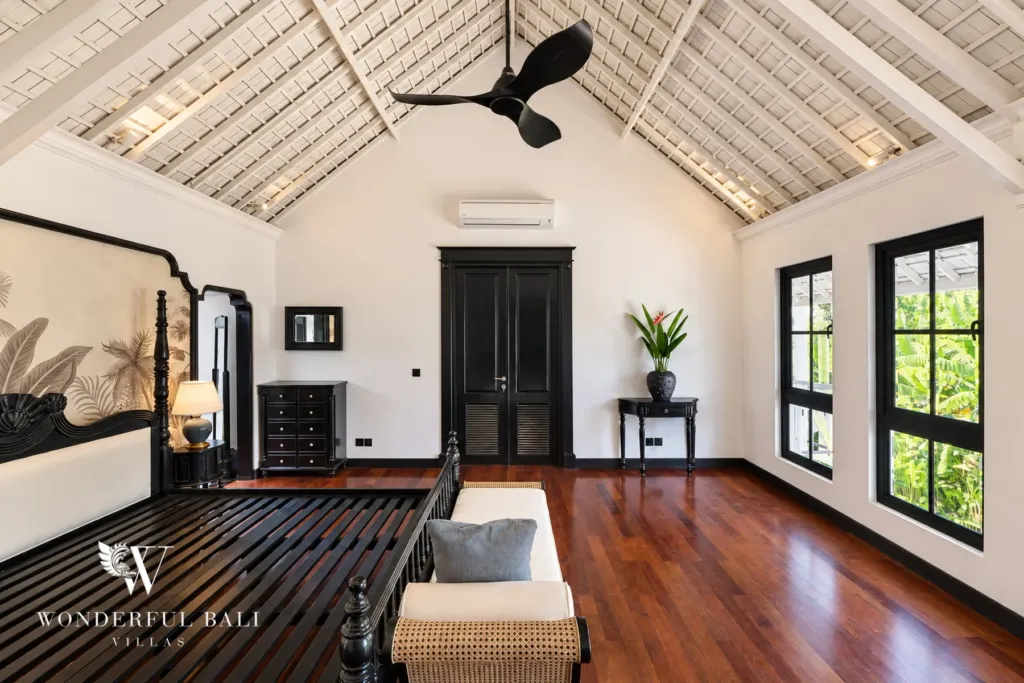 7BR villa for sale in Umalas — main suite under a vaulted timber ceiling with garden windows