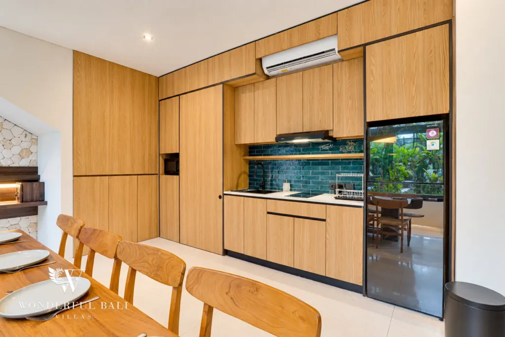 4BR villa for sale in Canggu — timber kitchen with tiled splashback and fridge