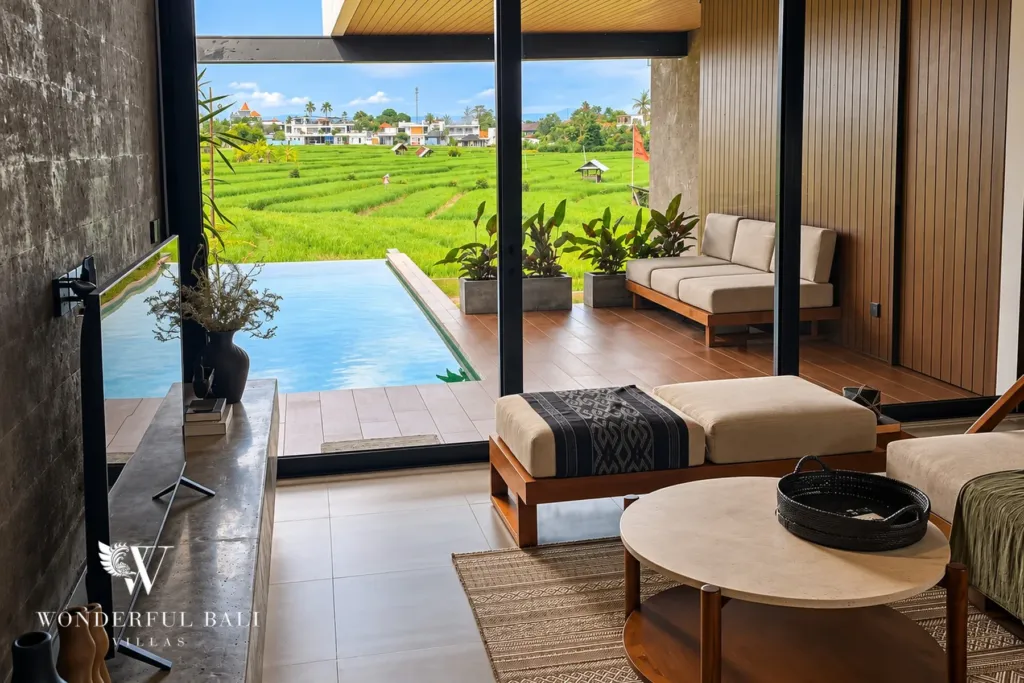 3BR villa long term rental Canggu — living room with rice field view through glass doors