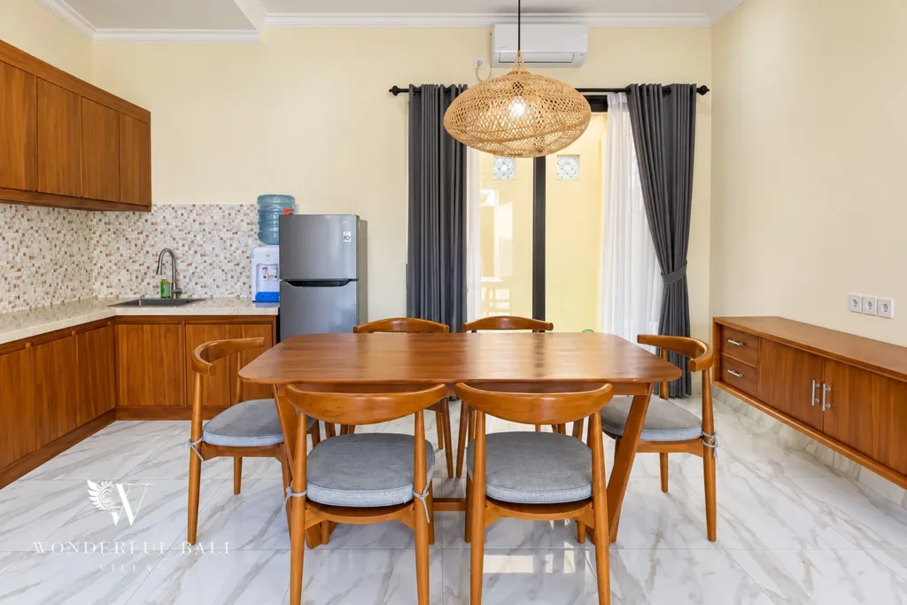 3BR villa for sale or rent in Sanur — dining area with kitchen and glass doors to the garden