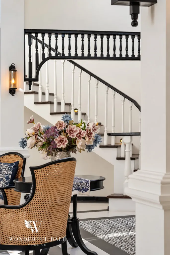7BR villa for sale in Umalas — curved staircase with black balustrade beside a reading nook