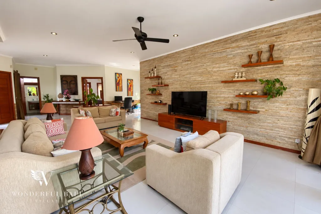 3BR villa for rent in Sanur — living room with TV on the stone wall