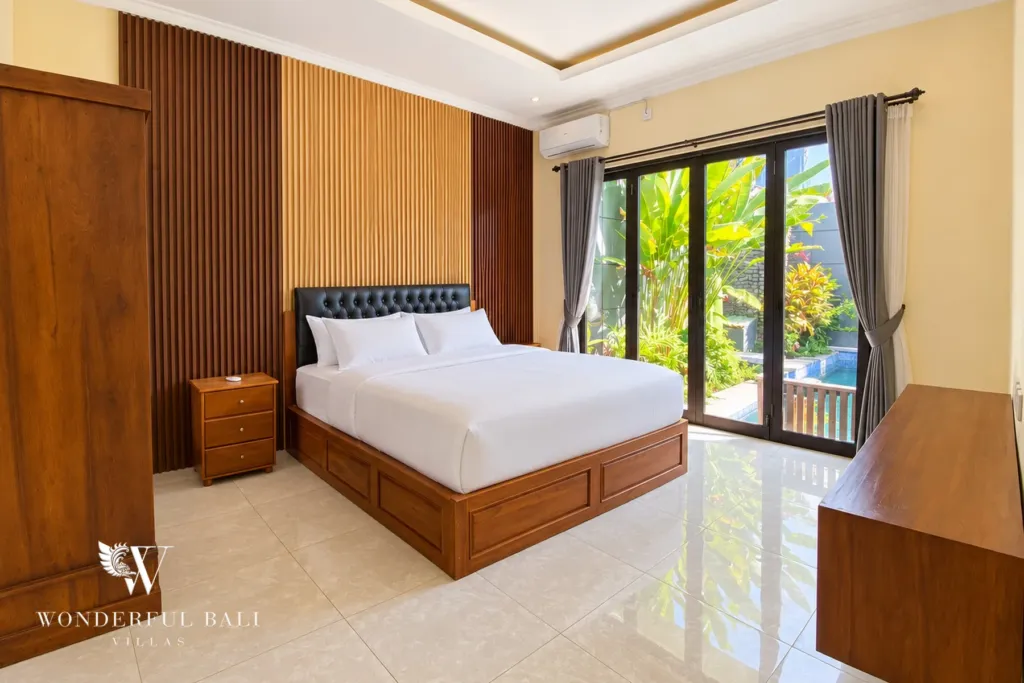 3BR villa for sale or rent in Sanur — bedroom with glass doors to the garden
