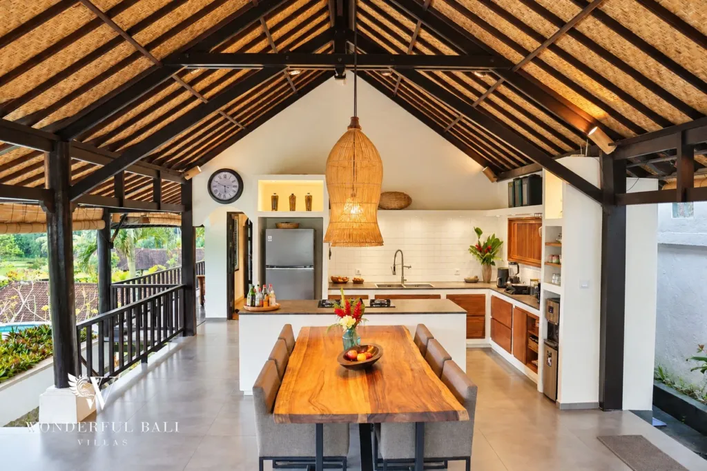3BR villa for rent in Tabanan — open kitchen with fridge and dining table under a timber roof