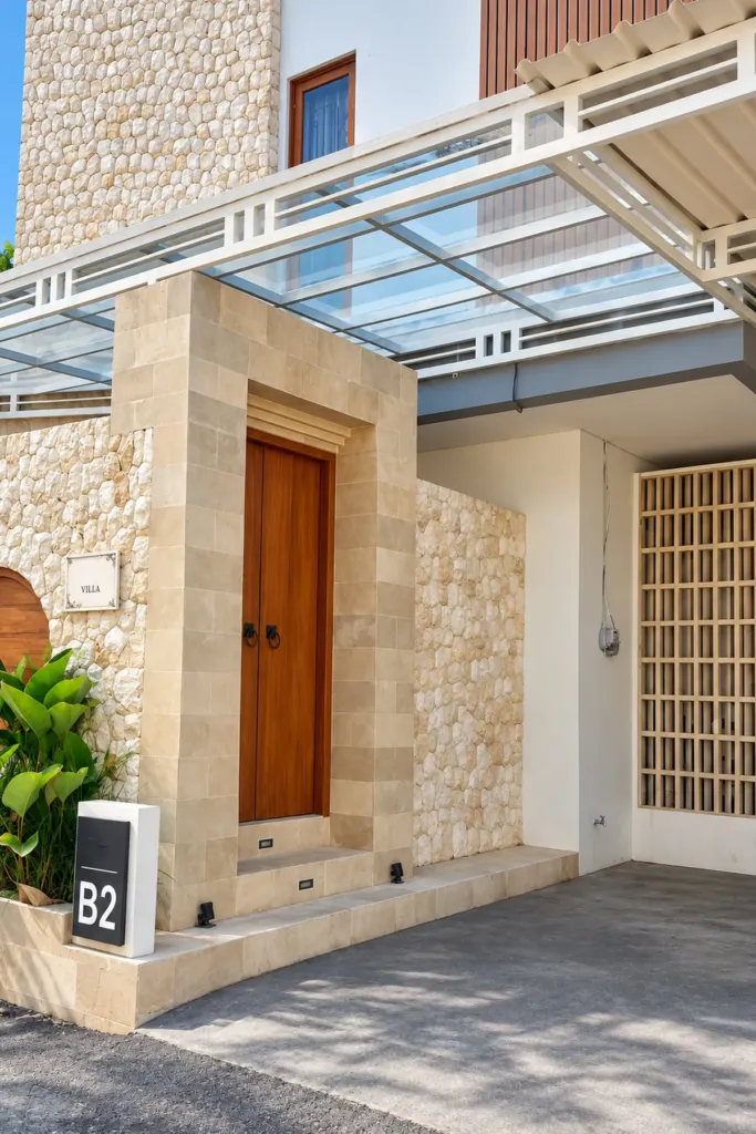 3BR villa for rent in Sanur — villa entrance with teak door, limestone frame and covered carport