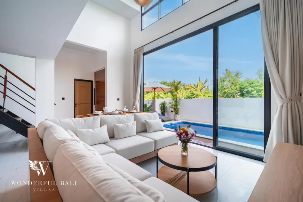 3BR villa for sale in Saba, Gianyar — living room with full-height glass doors to the pool