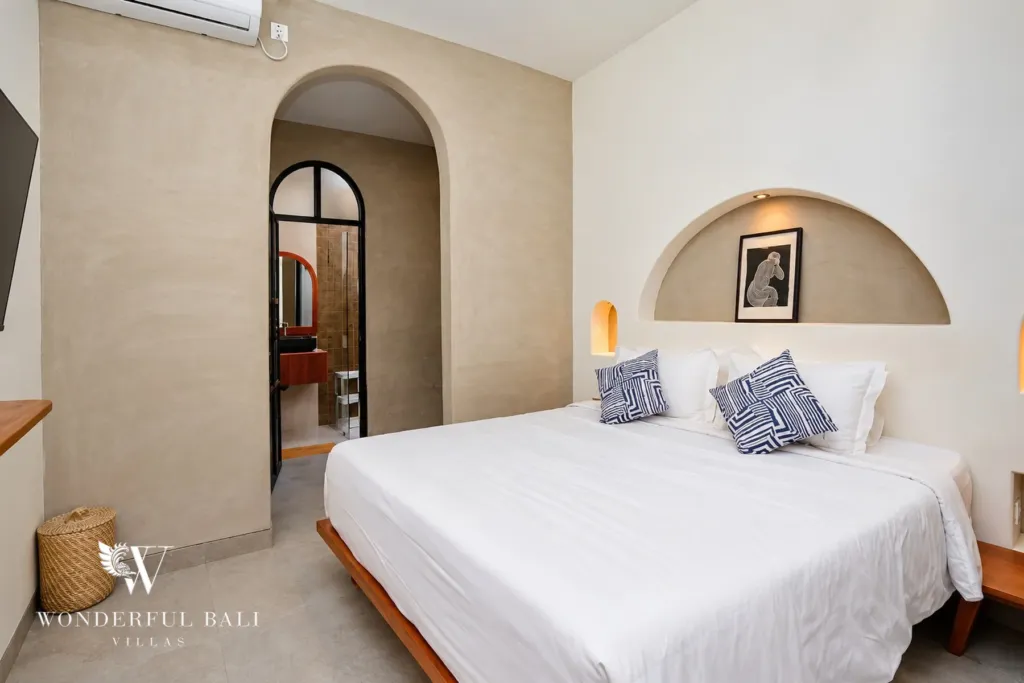 2BR villa for sale in Sanur — bedroom with arched doorway to the ensuite