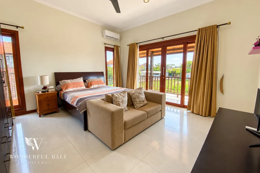 3BR villa for rent in Sanur — bedroom with sofa and balcony doors