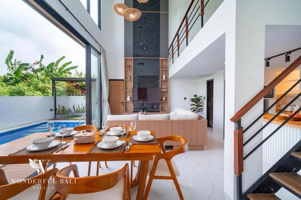 3BR villa for sale in Saba, Gianyar — double-height dining area with staircase and pool view
