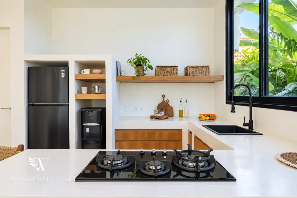 2BR villa for rent in Munggu — gas hob and sink under a garden window