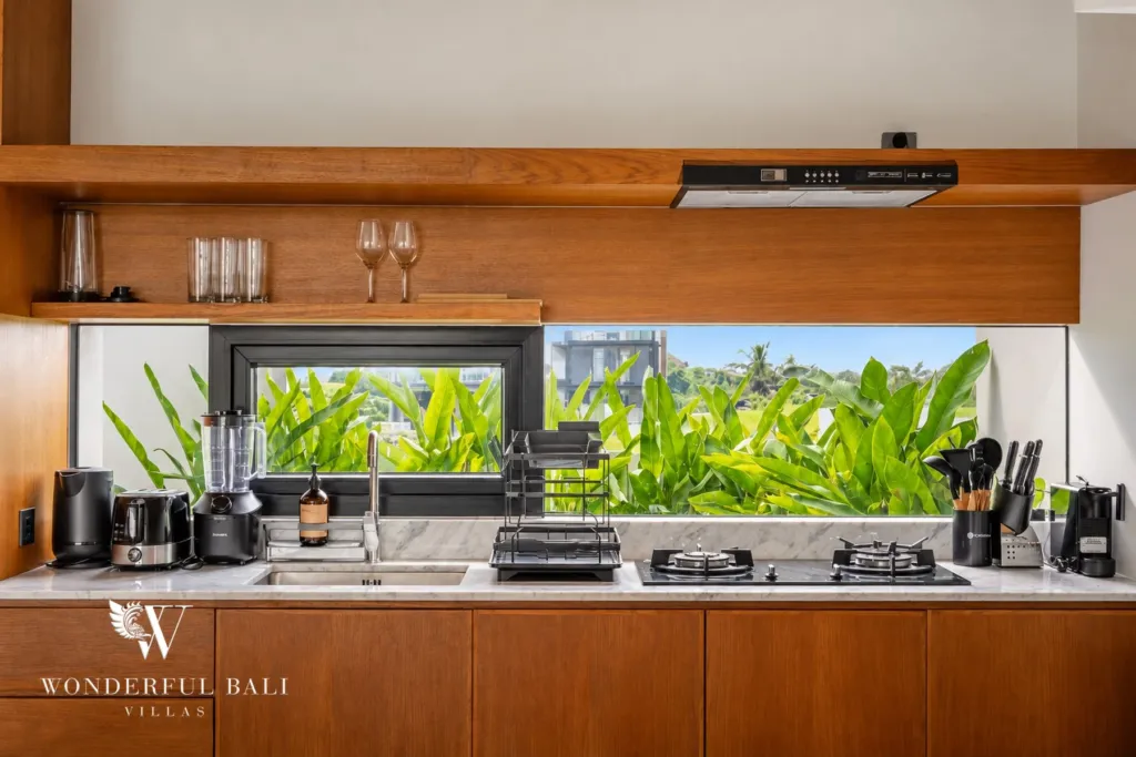 3BR villa long term rental Canggu — kitchen counter with window onto tropical planting