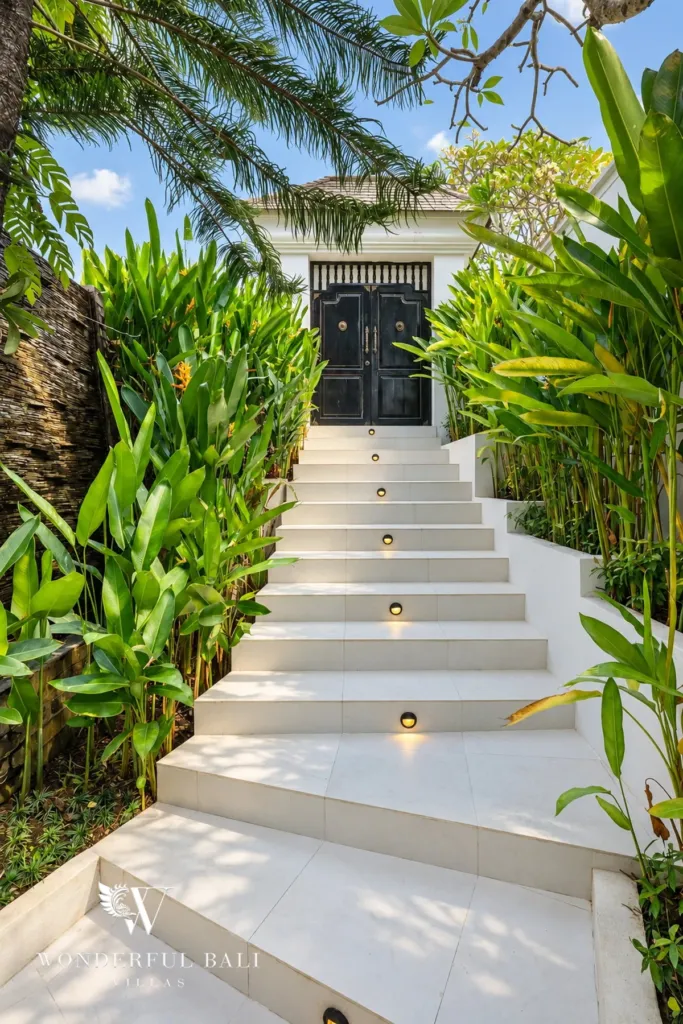 7BR villa for sale in Umalas — lit stone steps through tropical planting to the front door