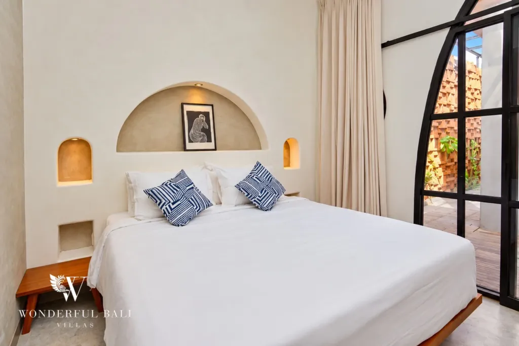 2BR villa for sale in Sanur — bedroom with arched headboard and garden door