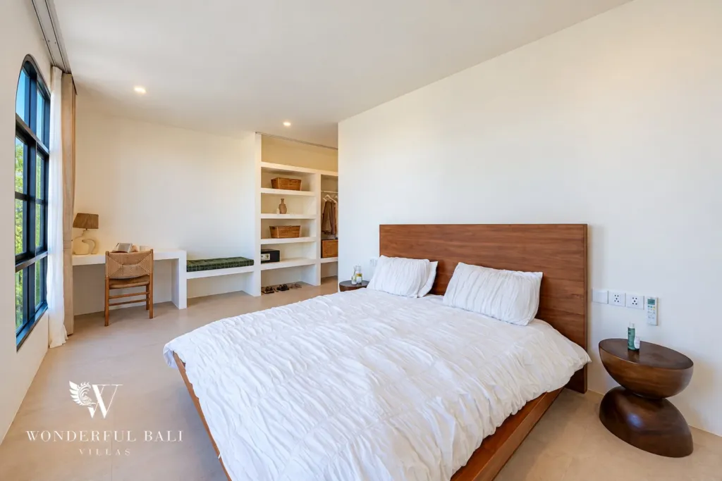 2BR villa for rent in Munggu — bedroom with timber headboard and arched window