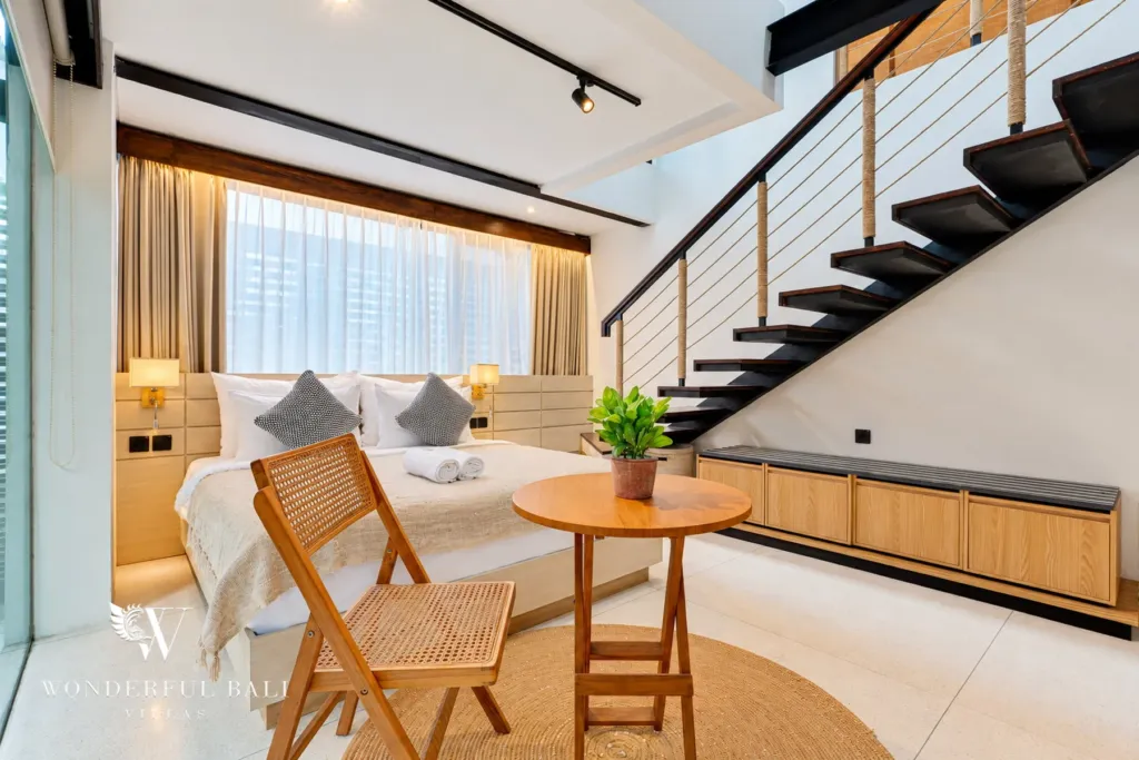 4BR villa for sale in Canggu — bedroom with stairs up to a loft