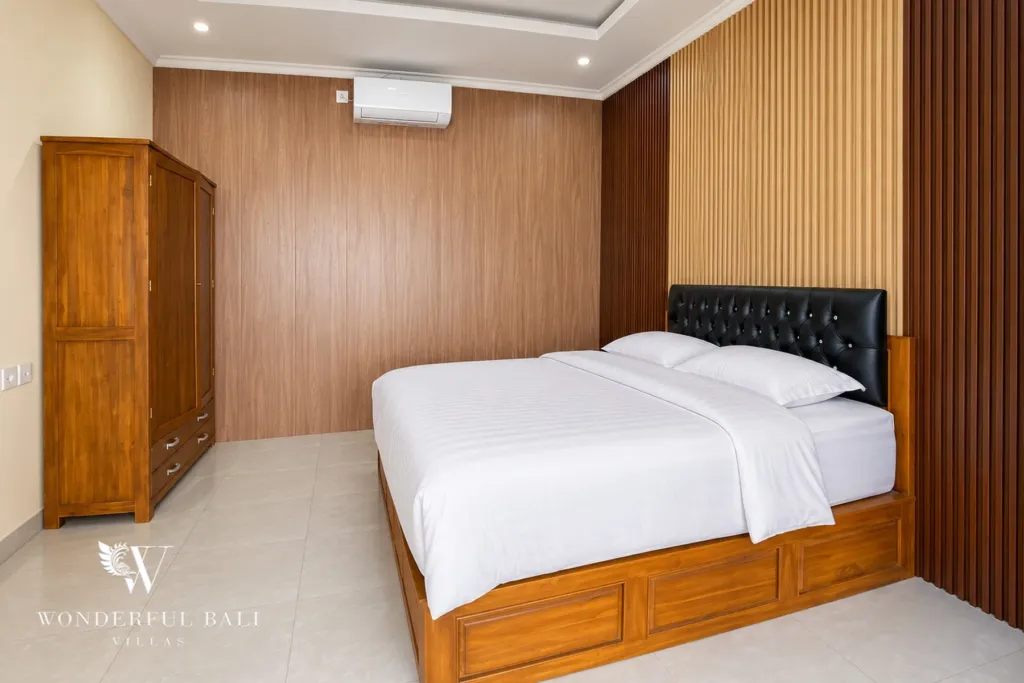 3BR villa for sale or rent in Sanur — second bedroom with timber-panelled wall and wardrobe