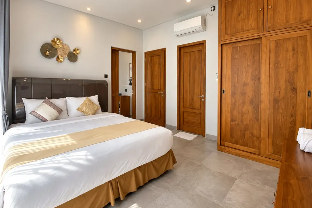 3BR villa for rent in Sanur — main bedroom with king bed and built-in teak wardrobe