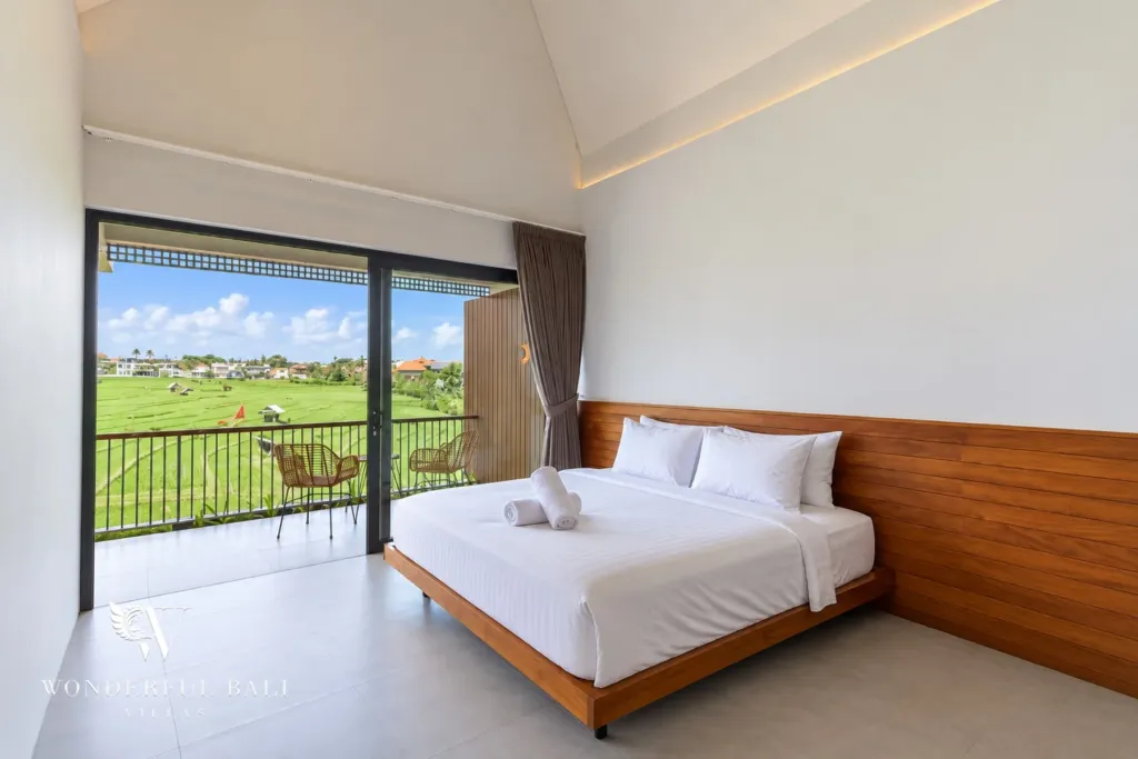 3BR villa long term rental Canggu — bedroom with balcony and rice field view
