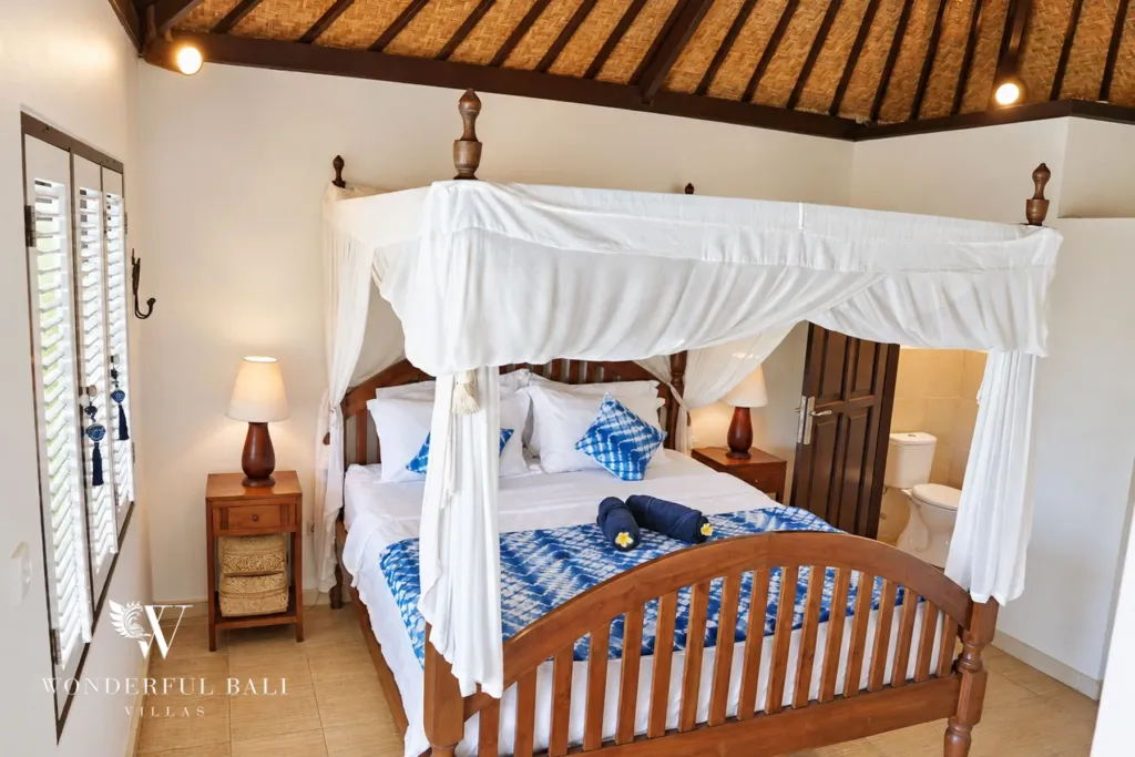 3BR villa for rent in Tabanan — four-poster bed with white canopy and louvred shutters