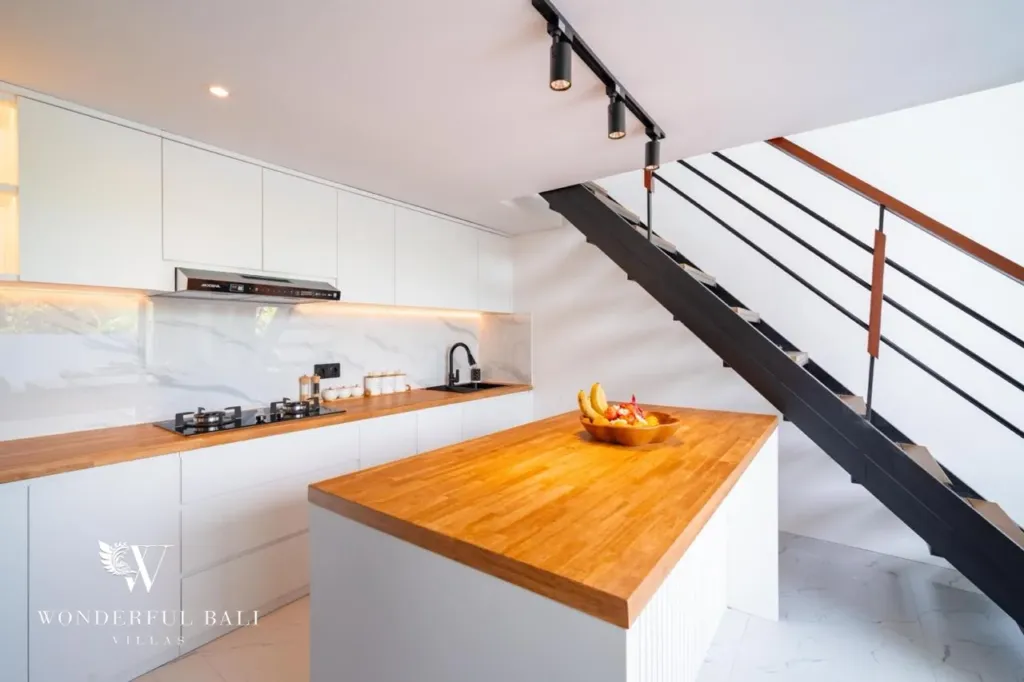 3BR villa for sale in Saba, Gianyar — kitchen island with hob and open staircase