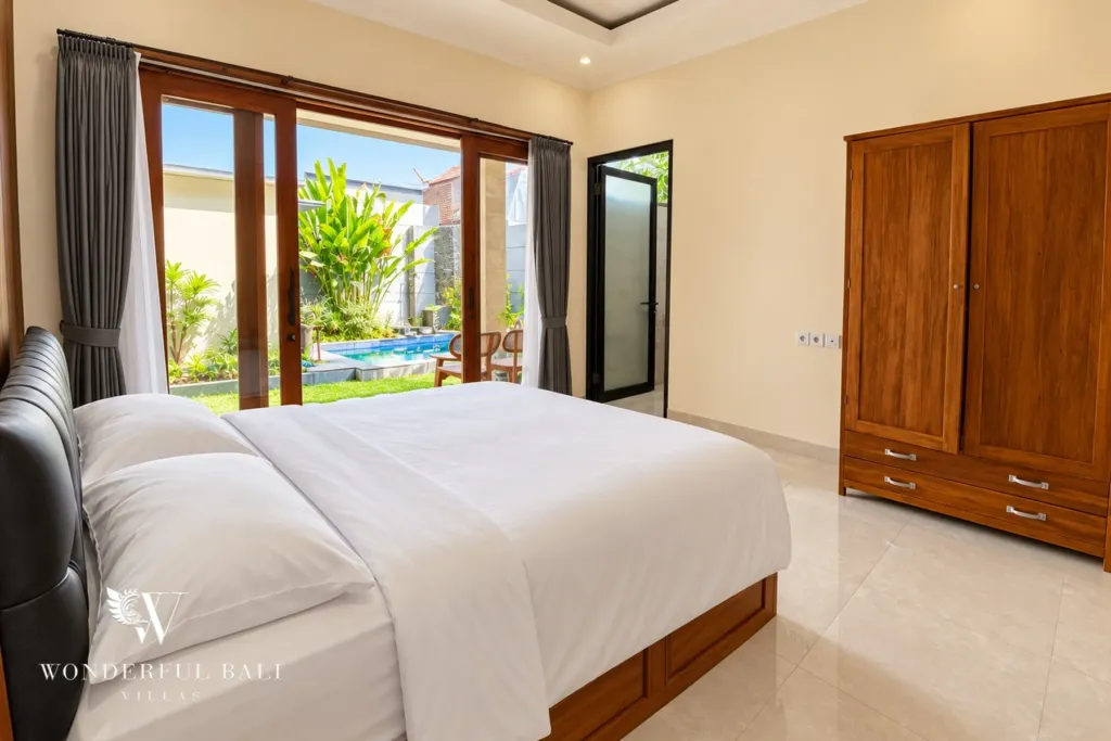 3BR villa for sale or rent in Sanur — second bedroom with glass doors to the garden