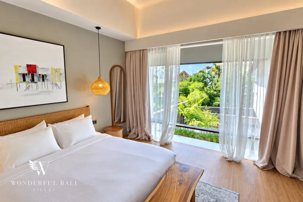2BR villa long term rental Pererenan — bedroom with balcony and treetop view