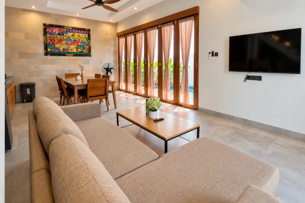 3BR villa for rent in Sanur — living room with smart TV and glass doors to the pool